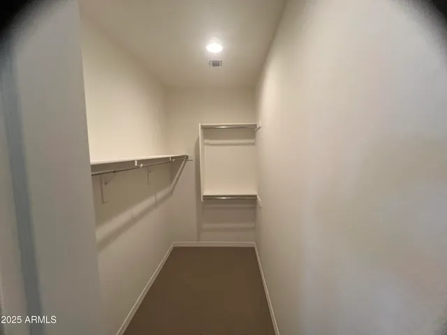 a bathroom with a granite countertop sink a mirror and shower