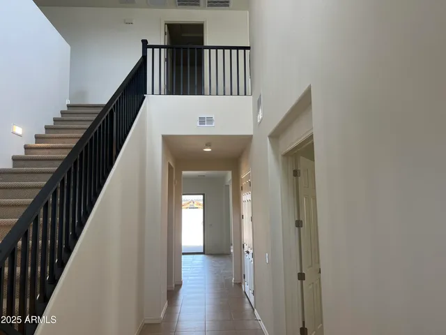 a view of entryway and hall with wooden floor