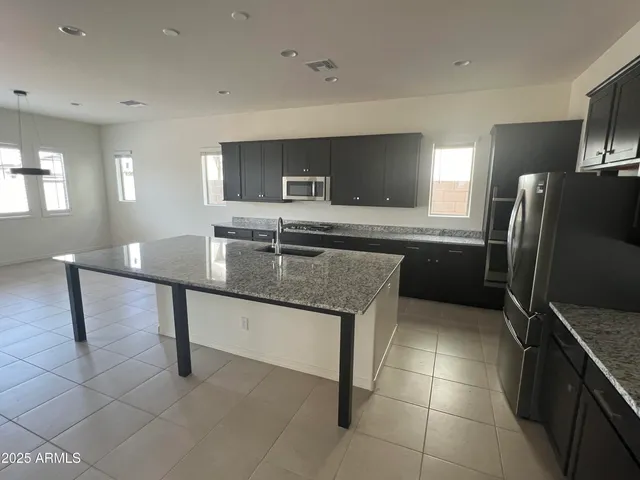a view of an empty room with a fireplace and a window