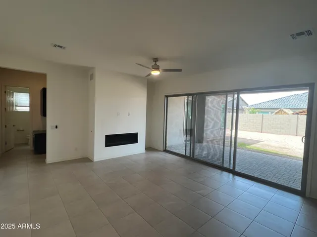 a large kitchen with kitchen island granite countertop a large counter top a stove a sink and refrigerator