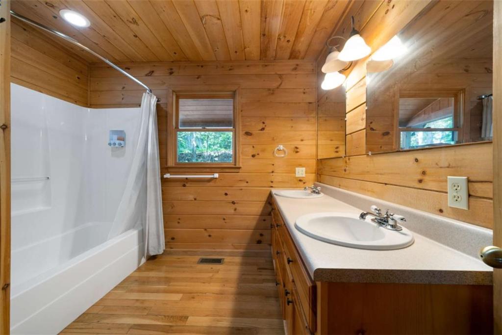 419 Blue Ridge Trail Morganton, GA 30560 - Photo 13 of 34 a bathroom with a sink a mirror and a shower