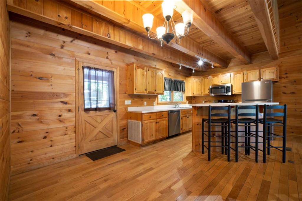 419 Blue Ridge Trail Morganton, GA 30560 - Photo 4 of 34 a kitchen with stainless steel appliances granite countertop a stove a sink dishwasher and a refrigerator with wooden floor