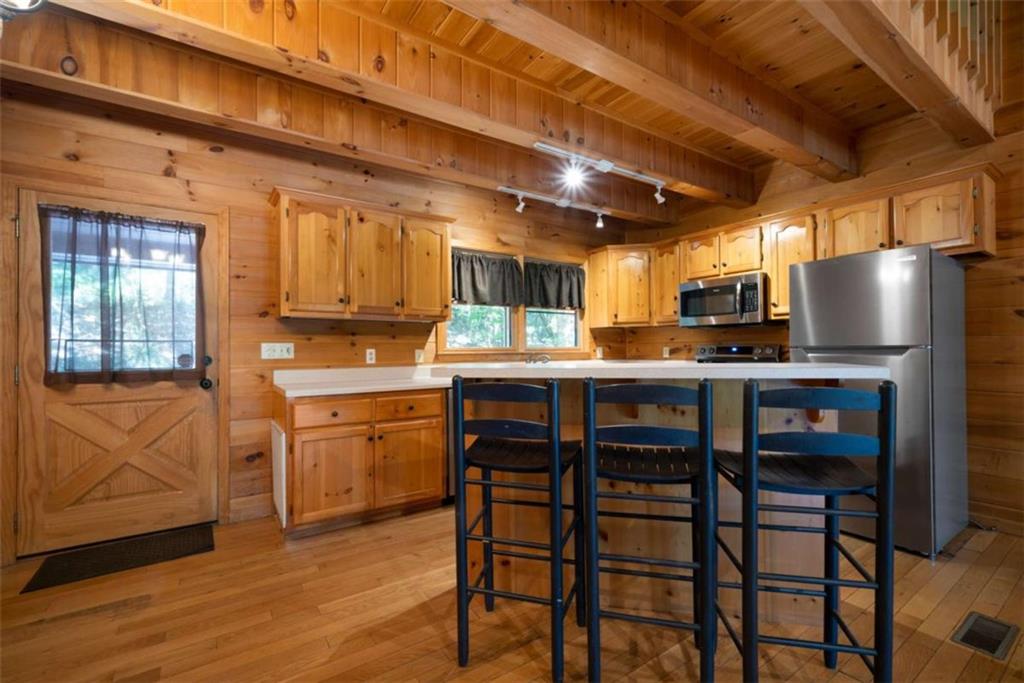 419 Blue Ridge Trail Morganton, GA 30560 - Photo 5 of 34 a kitchen with cabinets and wooden floor