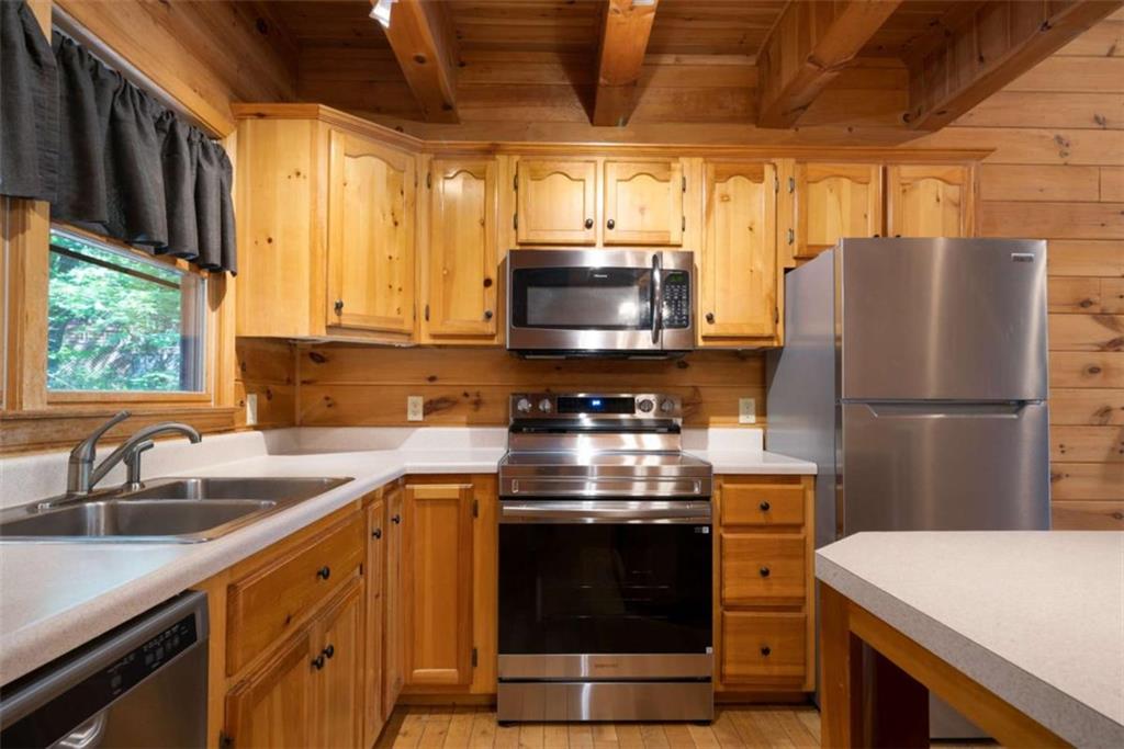 419 Blue Ridge Trail Morganton, GA 30560 - Photo 6 of 34 a kitchen with a stove a sink and a refrigerator
