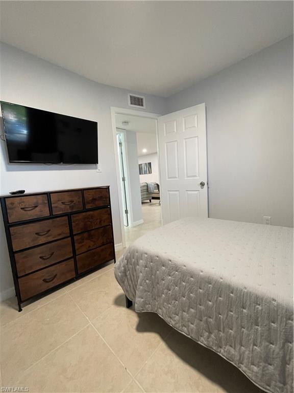170 Turtle Lake Court, Unit 103 Naples, FL 34105 - Photo 23 of 37 Bedroom featuring light tile patterned flooring
