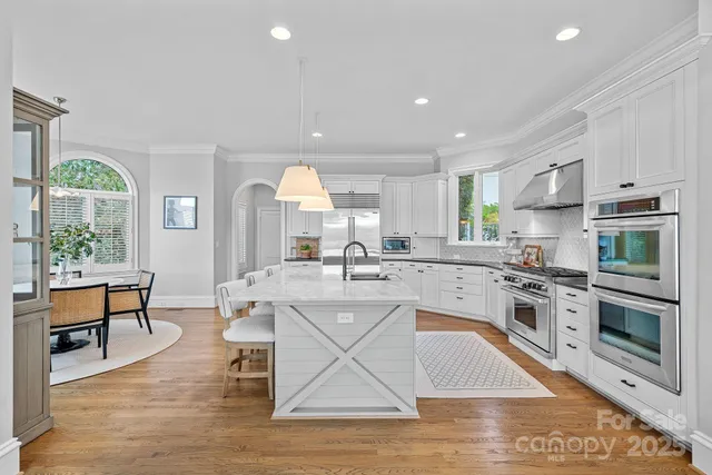a kitchen with a sink stainless steel appliances and cabinets