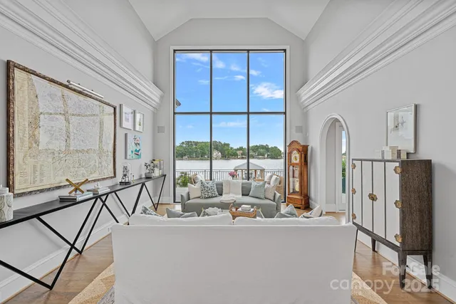 a living room with furniture a large window and a glass door