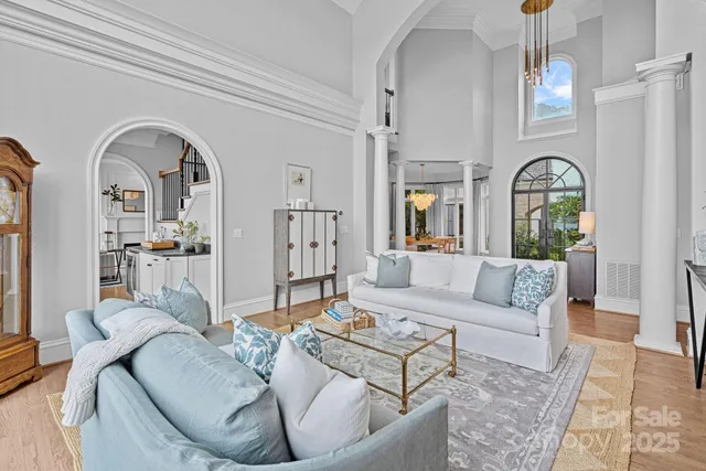 a living room with fireplace furniture and a large window