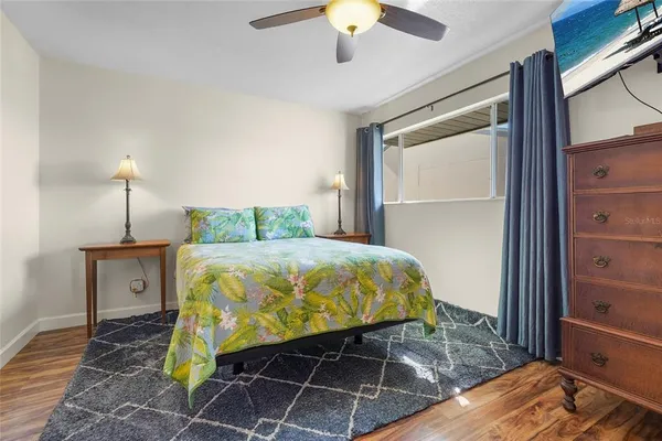a bedroom with a bed and a mirror