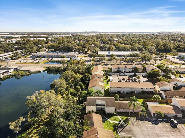an aerial view of a houses with a swimming pool