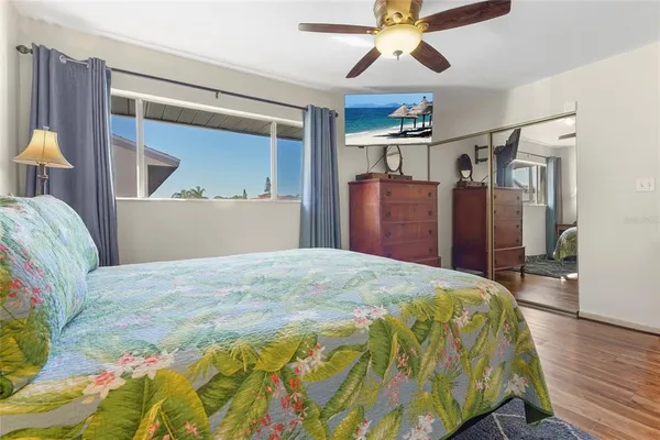 a spacious bedroom with a bed and a dresser