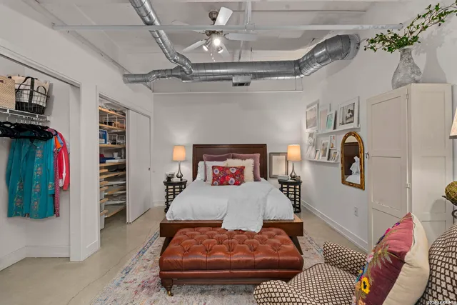 a bedroom with a bed and cabinets