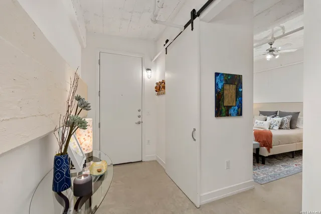 a bedroom with bed and a couch