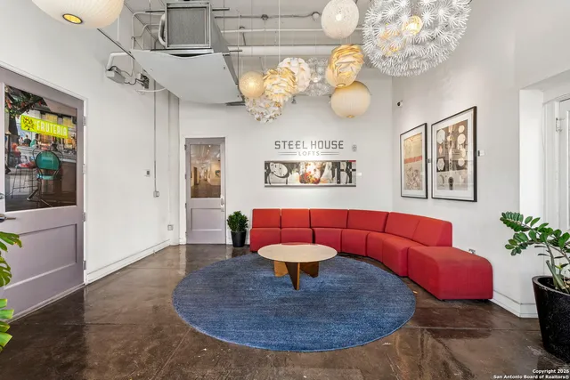 a living room with lots of furniture and a painting on the wall