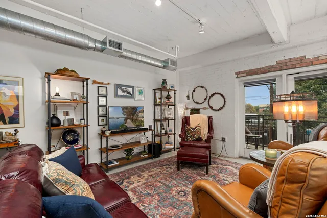 a living room with lots of furniture and kitchen view