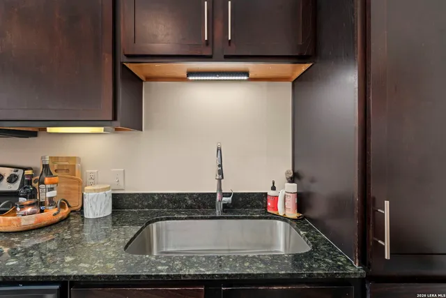 a kitchen with stainless steel appliances wooden cabinets a stove and a microwave