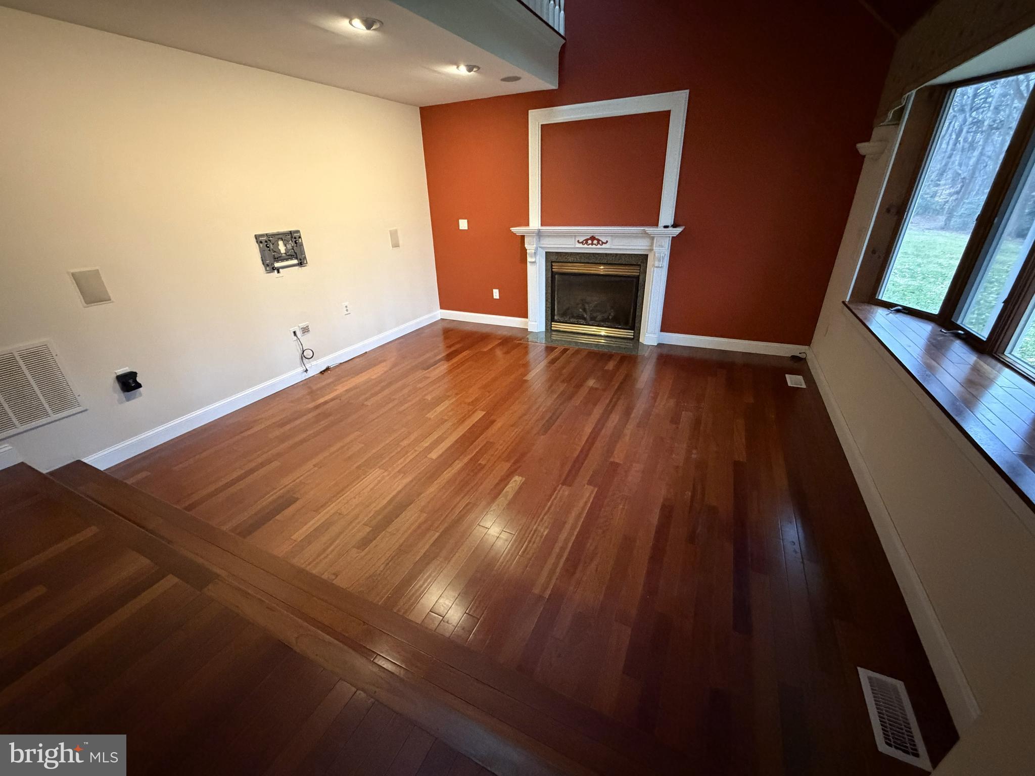 12803 Molly Berry Road Upper Marlboro, MD 20772 - Photo 17 of 61 a view of empty room with wooden floor and fireplace