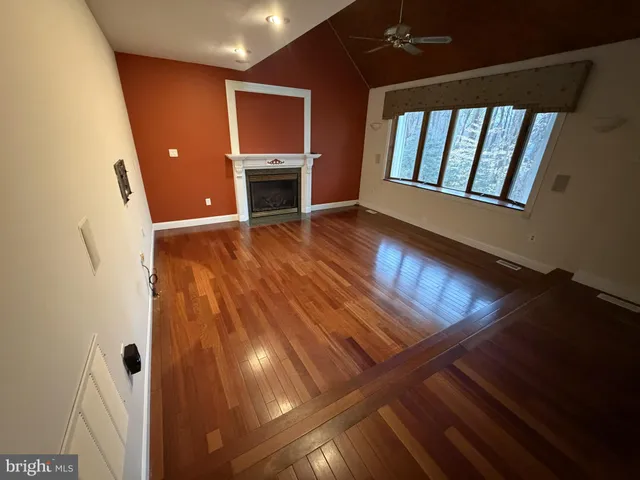 a view of an empty room and wooden floor