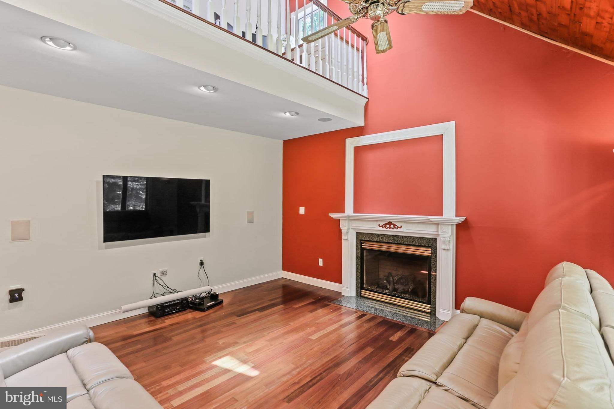 12803 Molly Berry Road Upper Marlboro, MD 20772 - Photo 20 of 61 a living room with furniture flat screen tv and a fireplace
