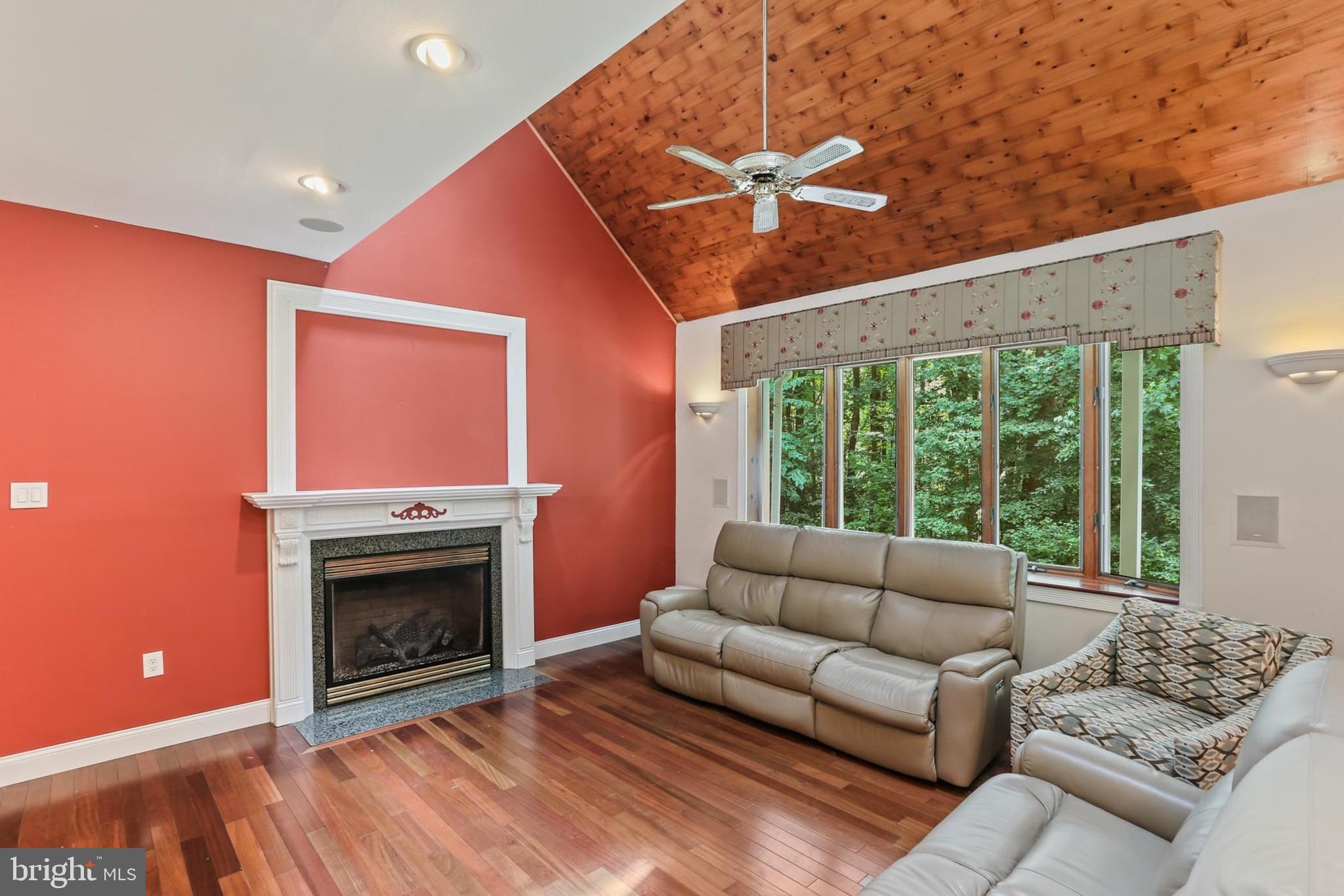 12803 Molly Berry Road Upper Marlboro, MD 20772 - Photo 21 of 61 a living room with furniture a large window and a fireplace