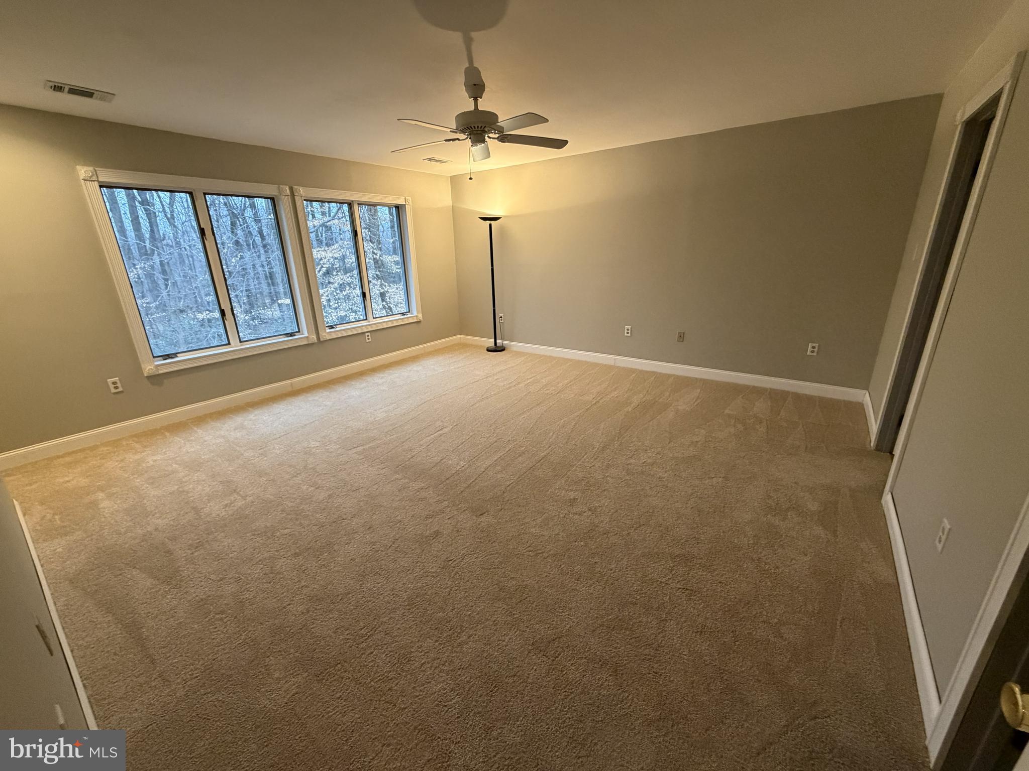 12803 Molly Berry Road Upper Marlboro, MD 20772 - Photo 29 of 61 en empty room with windows and chandelier