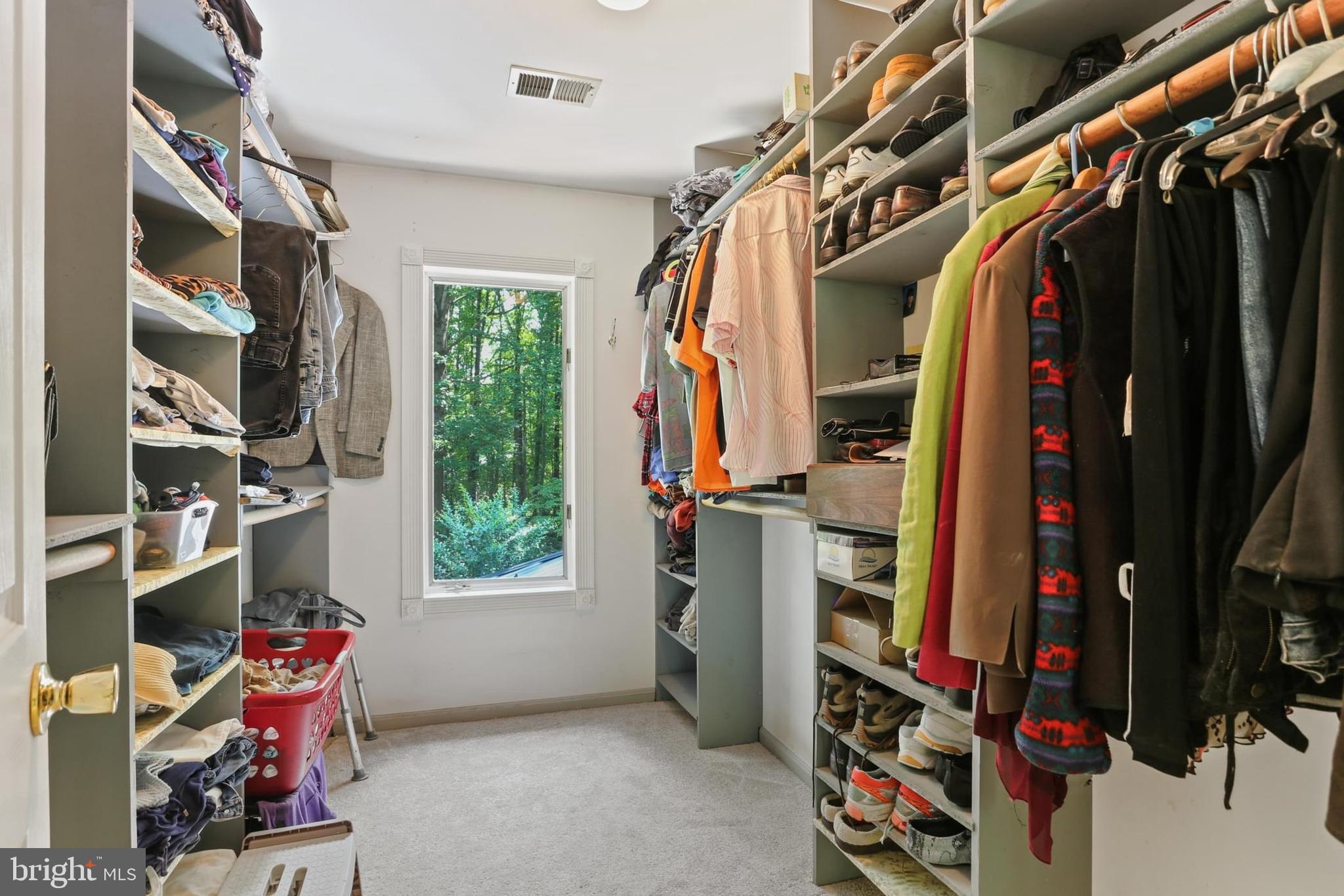 12803 Molly Berry Road Upper Marlboro, MD 20772 - Photo 33 of 61 a view of walk in closet with clothes and shoes