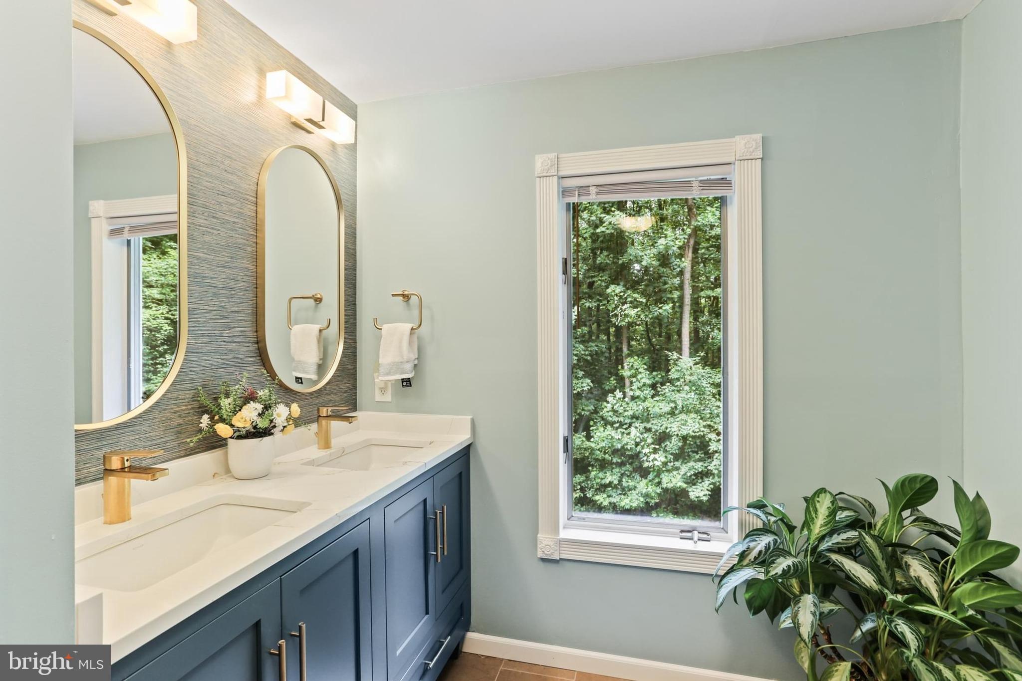 12803 Molly Berry Road Upper Marlboro, MD 20772 - Photo 38 of 61 a bathroom with a granite countertop sink a mirror and a window