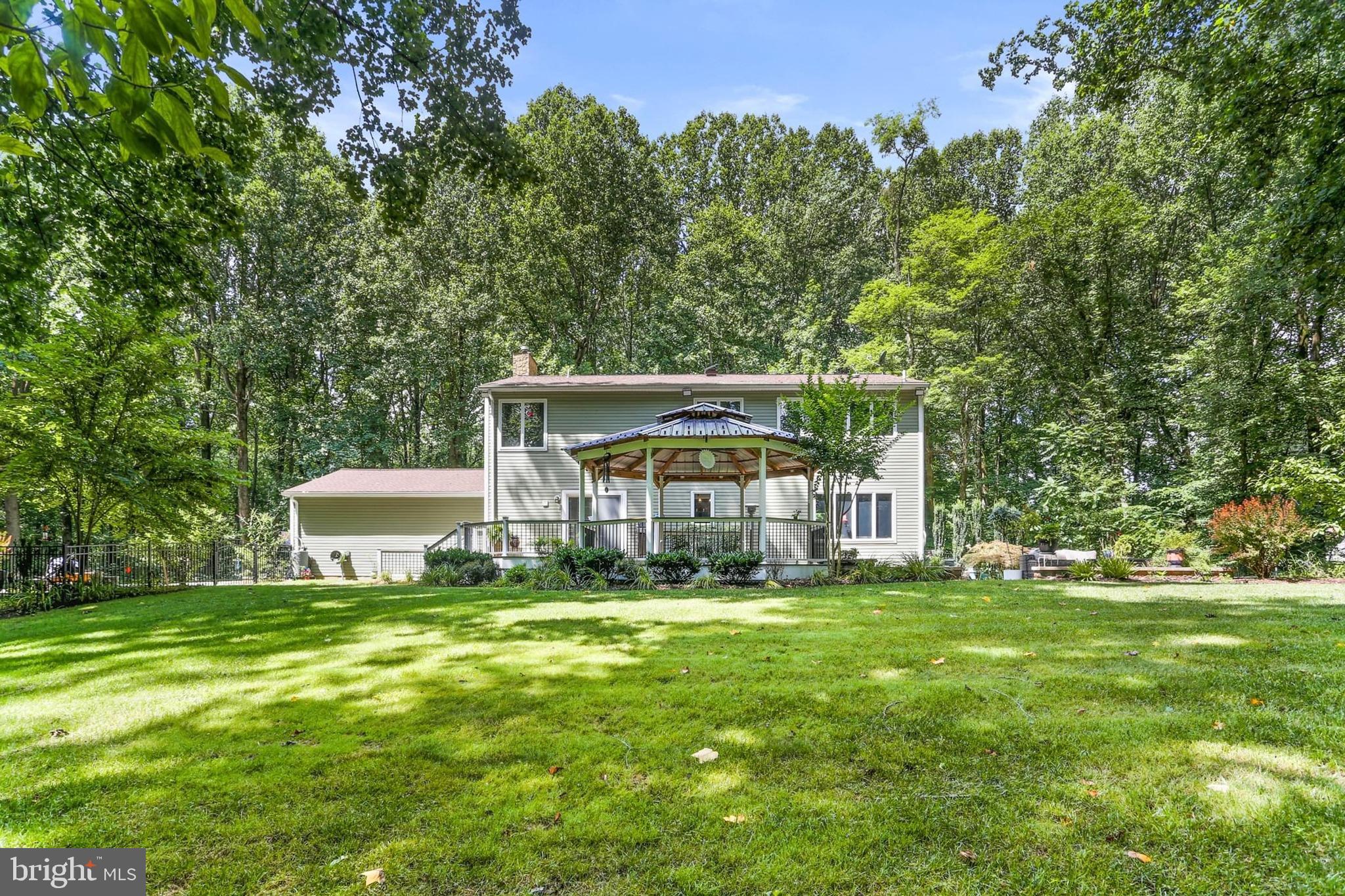 12803 Molly Berry Road Upper Marlboro, MD 20772 - Photo 4 of 61 a view of a house with a big yard and large trees