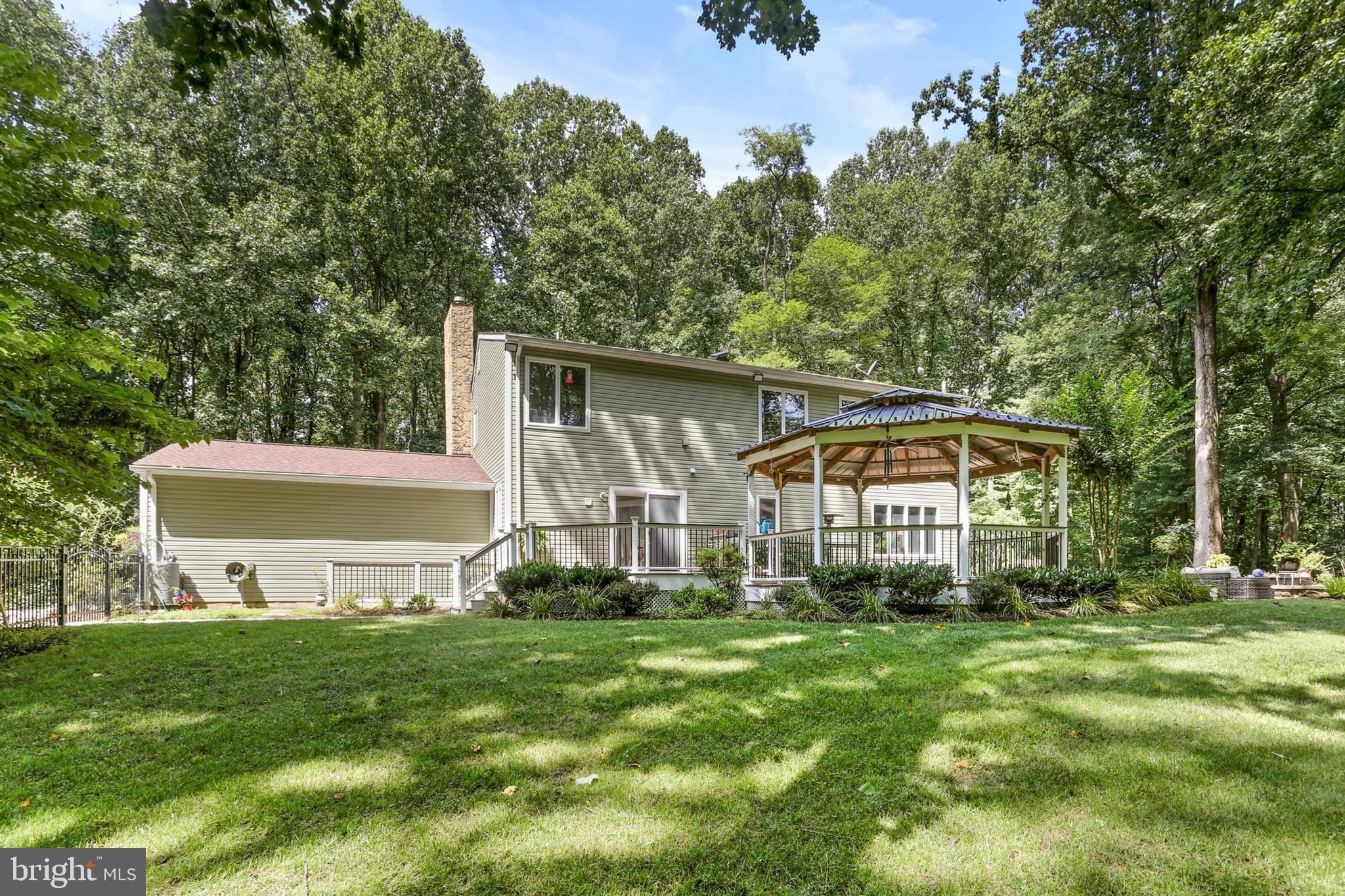 12803 Molly Berry Road Upper Marlboro, MD 20772 - Photo 50 of 61 a front view of a house with a yard and trees