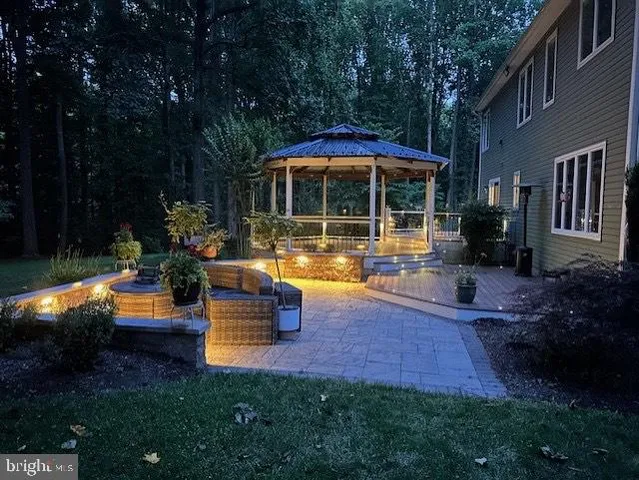 a view of a house with backyard sitting area and garden