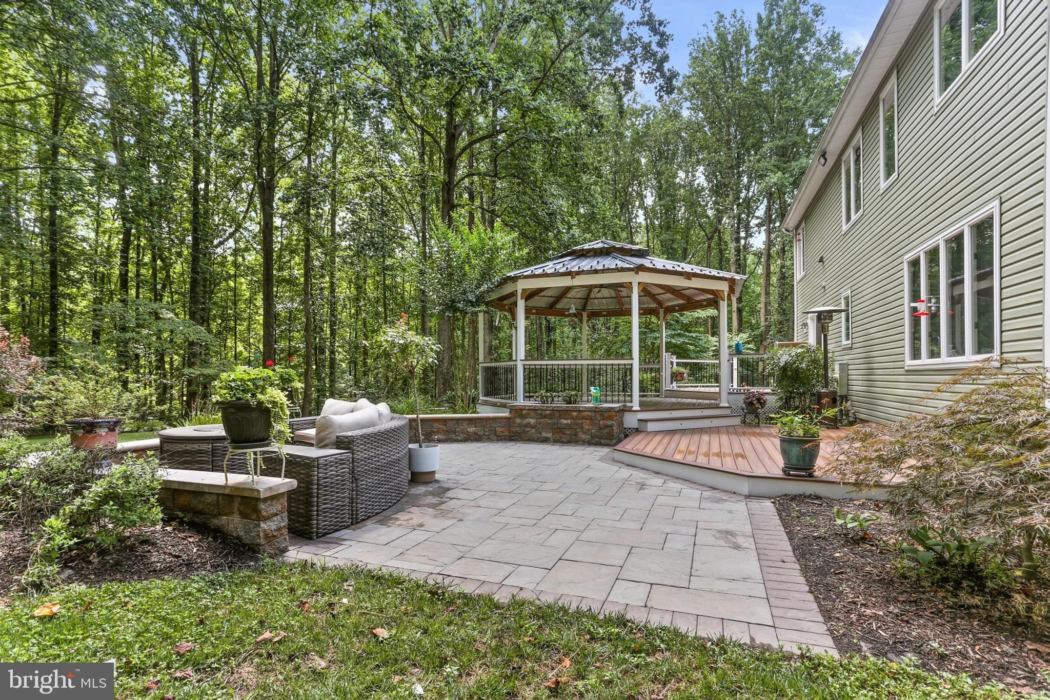 12803 Molly Berry Road Upper Marlboro, MD 20772 - Photo 55 of 61 a view of a house with backyard sitting area and garden