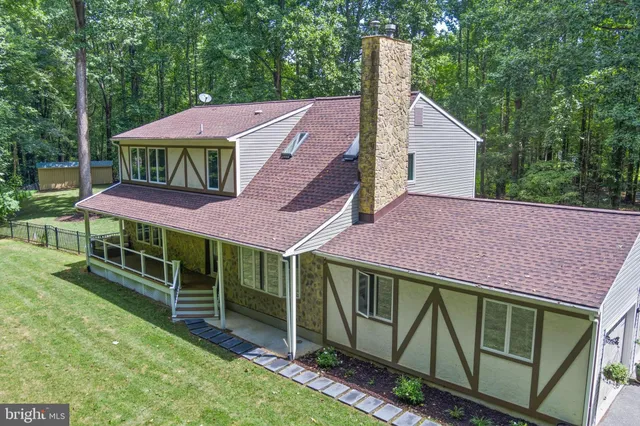 a aerial view of a house with a yard and furniture
