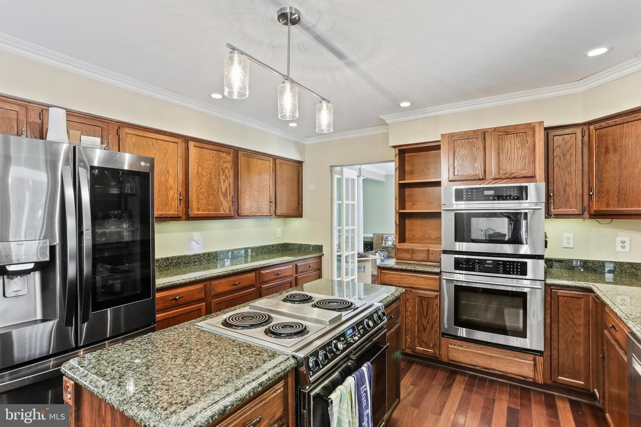 12803 Molly Berry Road Upper Marlboro, MD 20772 - Photo 9 of 61 a kitchen with stainless steel appliances granite countertop a stove sink and refrigerator