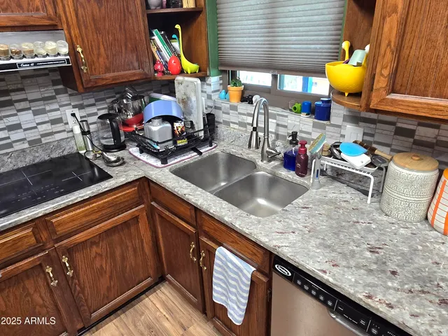 a kitchen with sink and cabinets