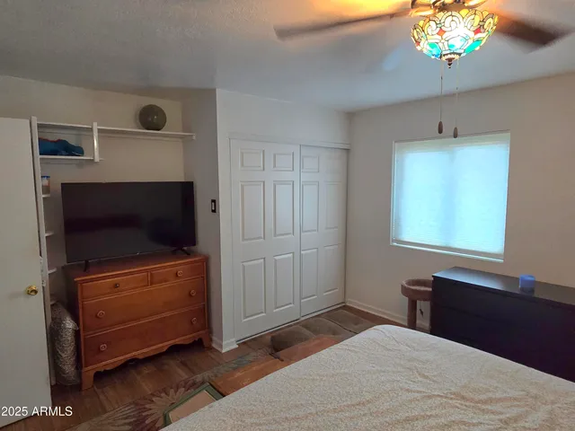 a bedroom with a bed and a flat screen tv