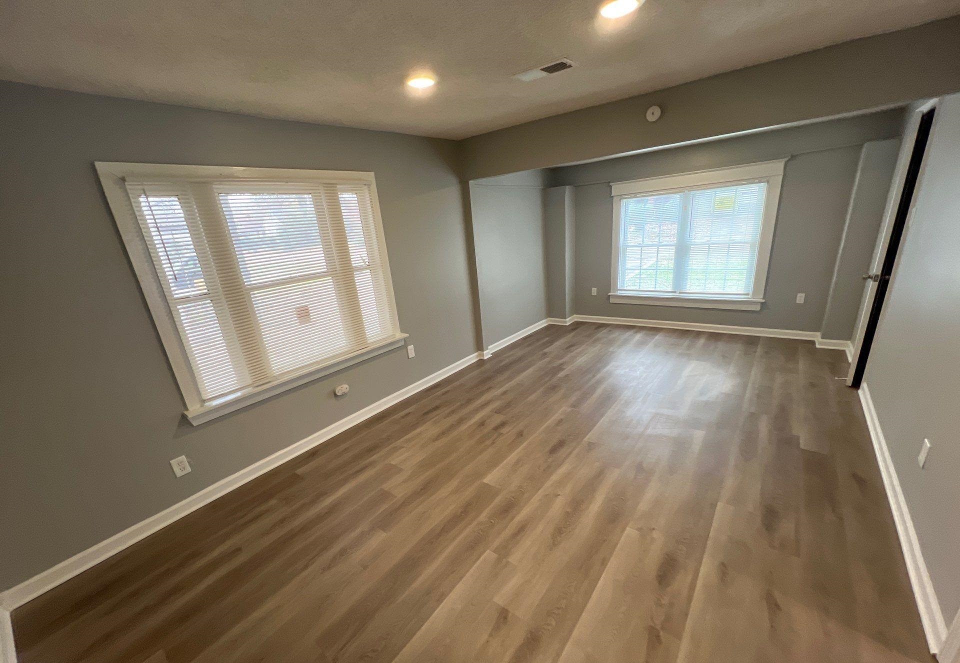 2974 Waverly Avenue Memphis, TN 38111 - Photo 11 of 13 an empty room with wooden floor and windows