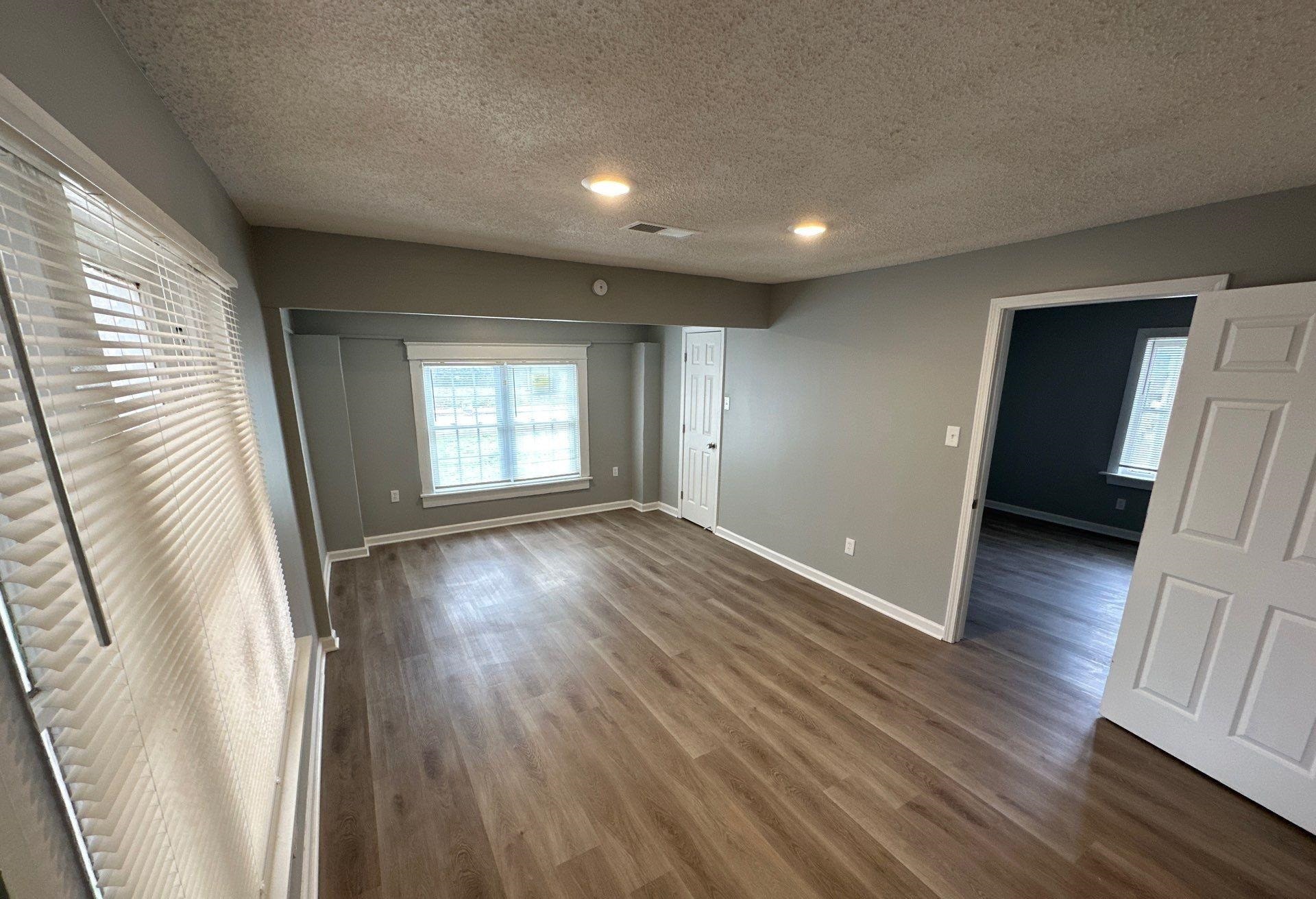 2974 Waverly Avenue Memphis, TN 38111 - Photo 4 of 13 wooden floor in an empty room with a window