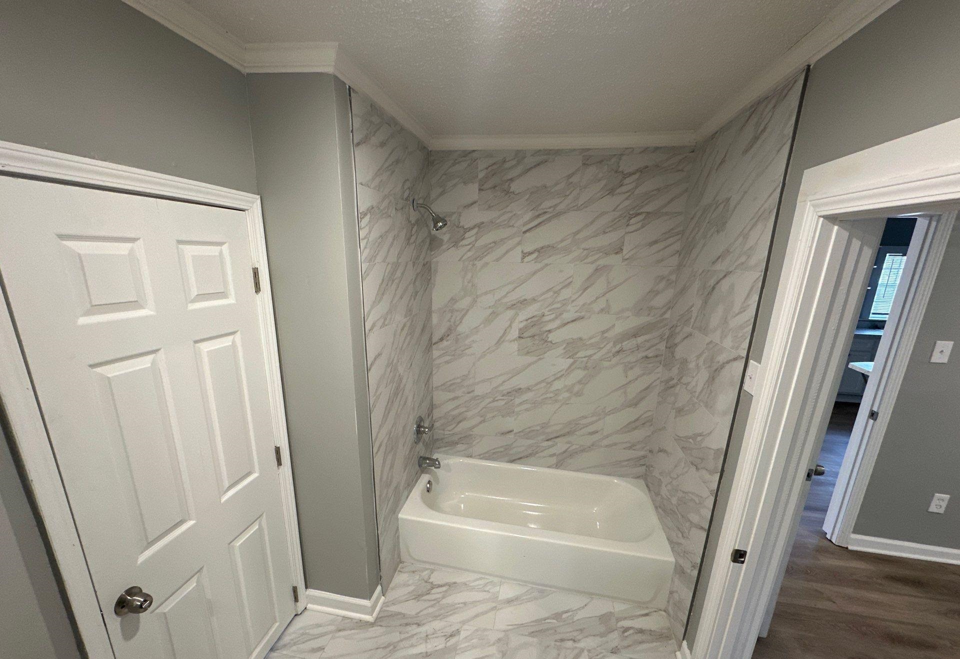 2974 Waverly Avenue Memphis, TN 38111 - Photo 6 of 13 a bathroom with a tub a sink and a shower