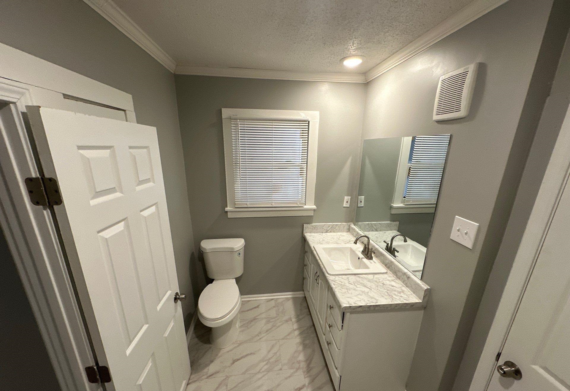 2974 Waverly Avenue Memphis, TN 38111 - Photo 8 of 13 a bathroom with a granite countertop sink toilet and shower