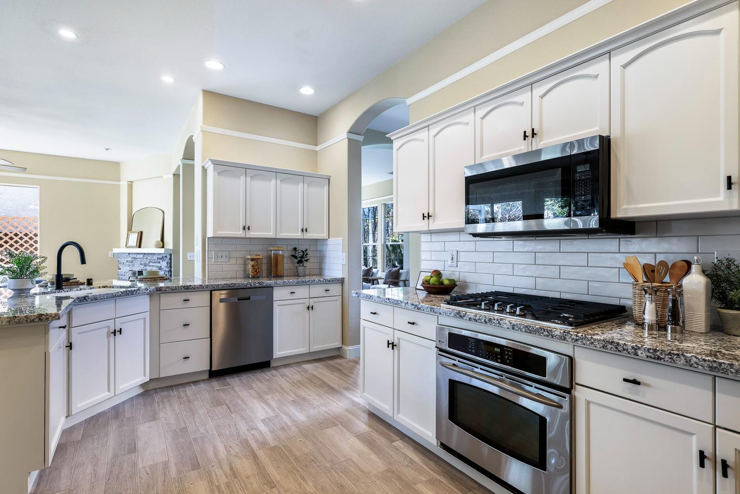 2735 Swift Avenue Clovis, CA 93611 - Photo 12 of 30 a kitchen with granite countertop a stove a sink and a microwave