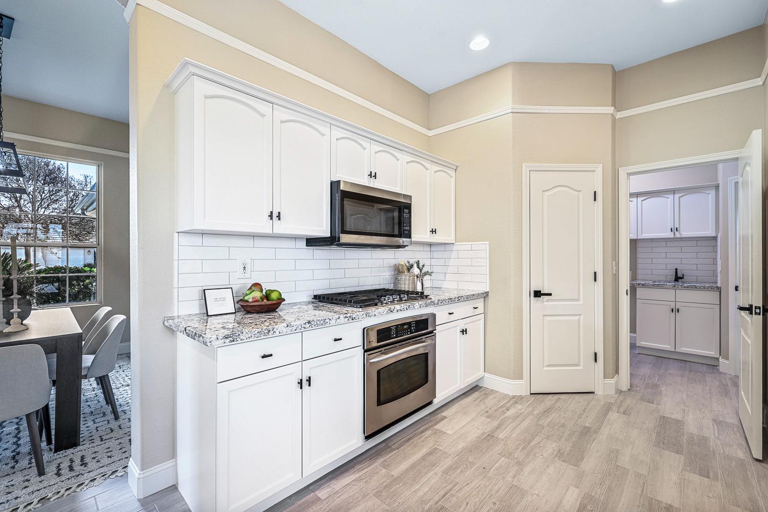 2735 Swift Avenue Clovis, CA 93611 - Photo 13 of 30 a kitchen with a stove a sink and a refrigerator