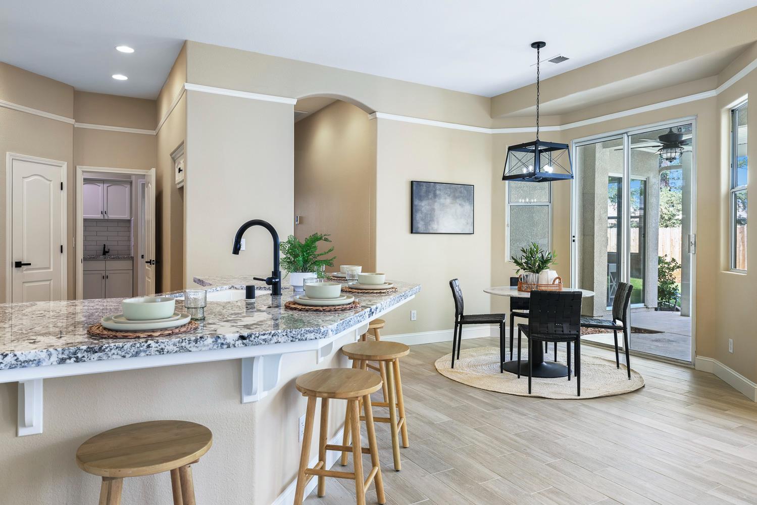 2735 Swift Avenue Clovis, CA 93611 - Photo 15 of 30 a dining room with wooden floor and large windows