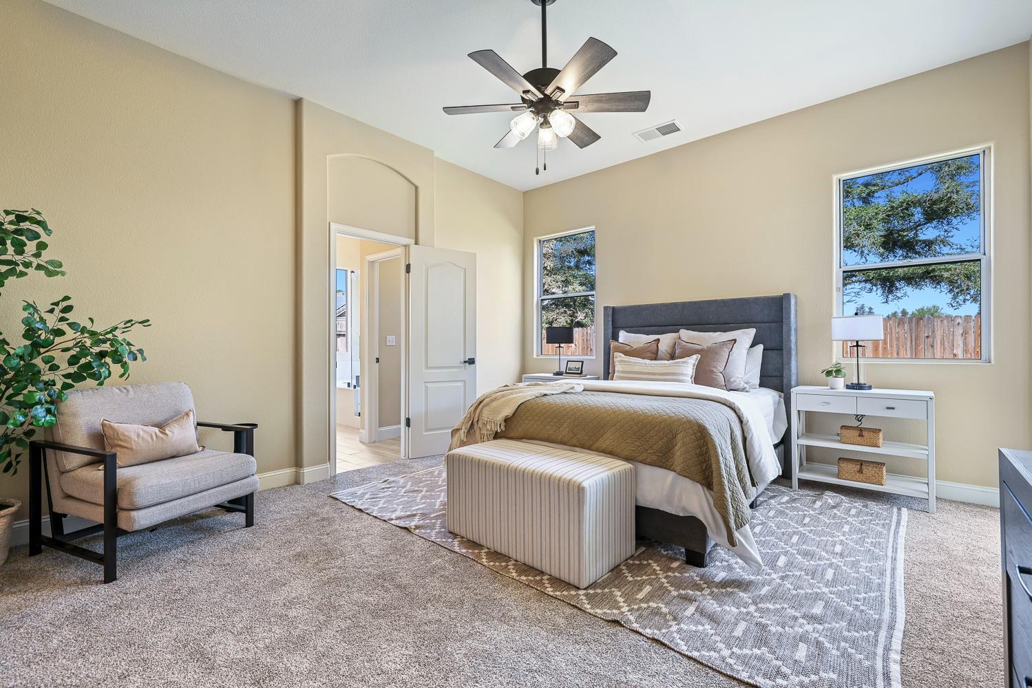 2735 Swift Avenue Clovis, CA 93611 - Photo 17 of 30 a bedroom with a bed and a chandelier