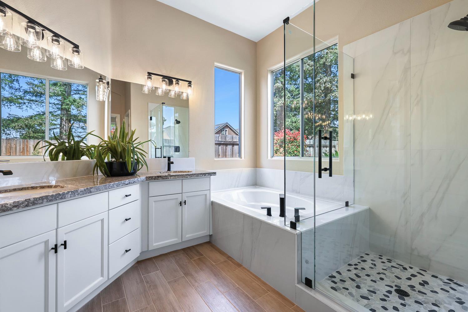 2735 Swift Avenue Clovis, CA 93611 - Photo 20 of 30 a bathroom with a double vanity sink and mirror with bathtub