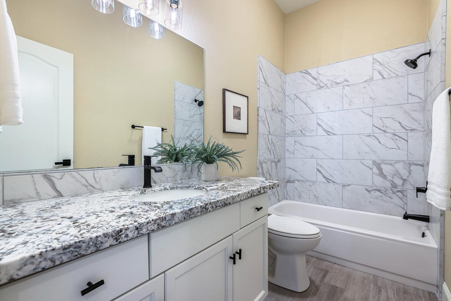 2735 Swift Avenue Clovis, CA 93611 - Photo 23 of 30 a bathroom with a granite countertop sink and a mirror