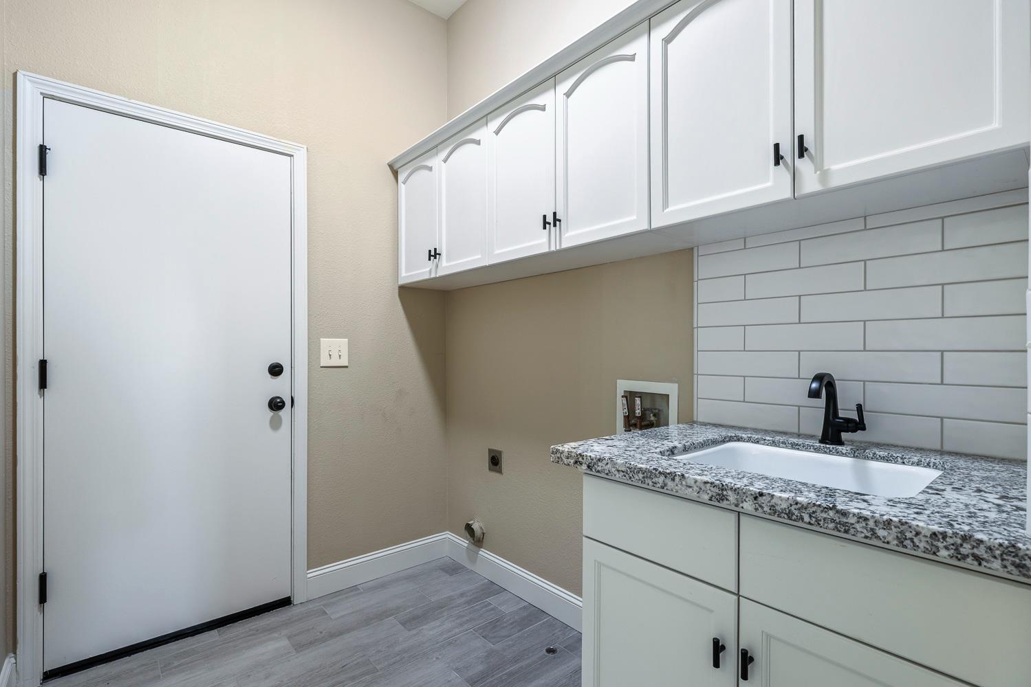2735 Swift Avenue Clovis, CA 93611 - Photo 25 of 30 a bathroom with a granite countertop sink and a mirror