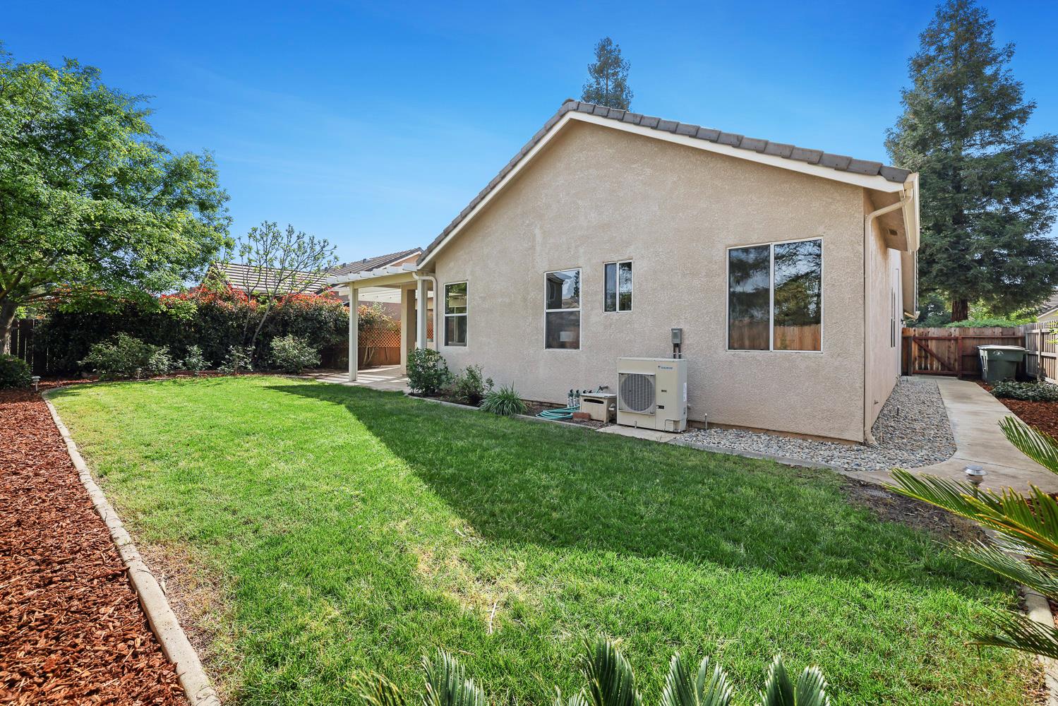 2735 Swift Avenue Clovis, CA 93611 - Photo 27 of 30 a view of backyard with a garden and plants