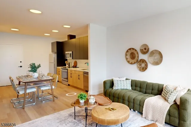 a living room with furniture kitchen view and a table