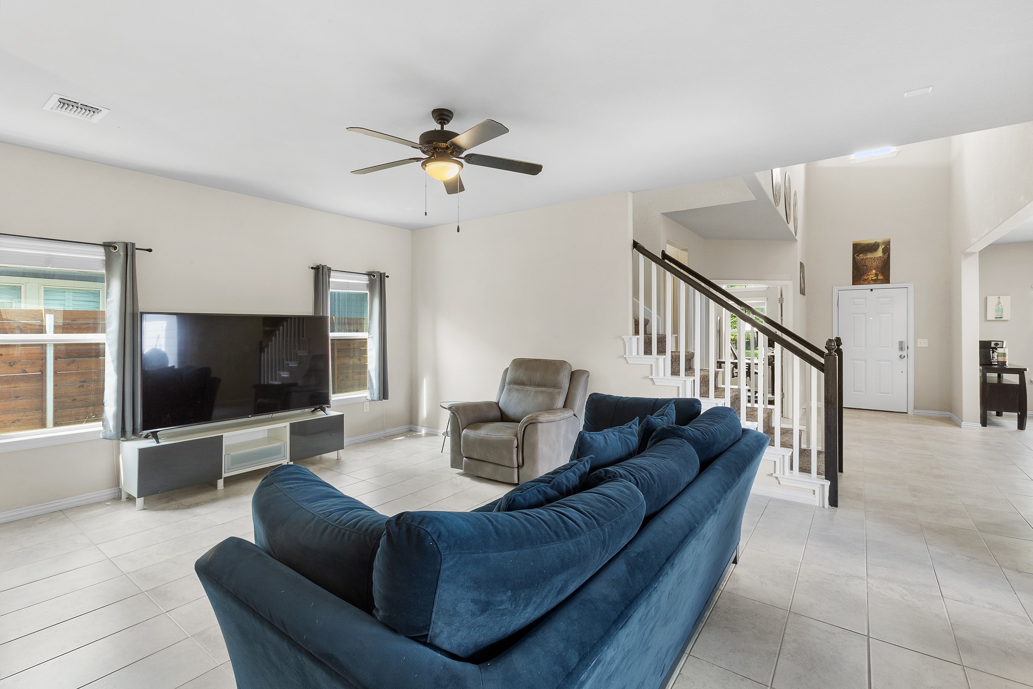 8709 Slater Drive Austin, TX 78747 - Photo 14 of 36 a living room with furniture and a flat screen tv
