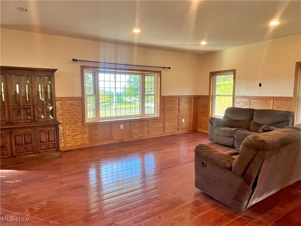 17583 Davis Ridge Road Caldwell, OH 43724 - Photo 16 of 42 Living area with plenty of natural light, recessed lighting, hardwood / wood-style floors, and a wainscoted wall